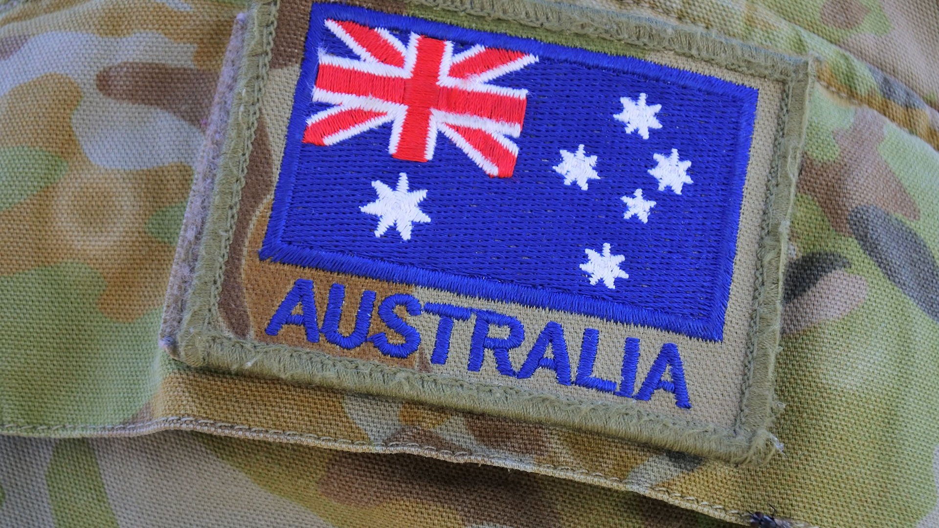 Australian Army flag on military camouflage uniform.Since 1947, the Australian Army has been involved wars and conflicts, usually under the auspices of the United Nations.